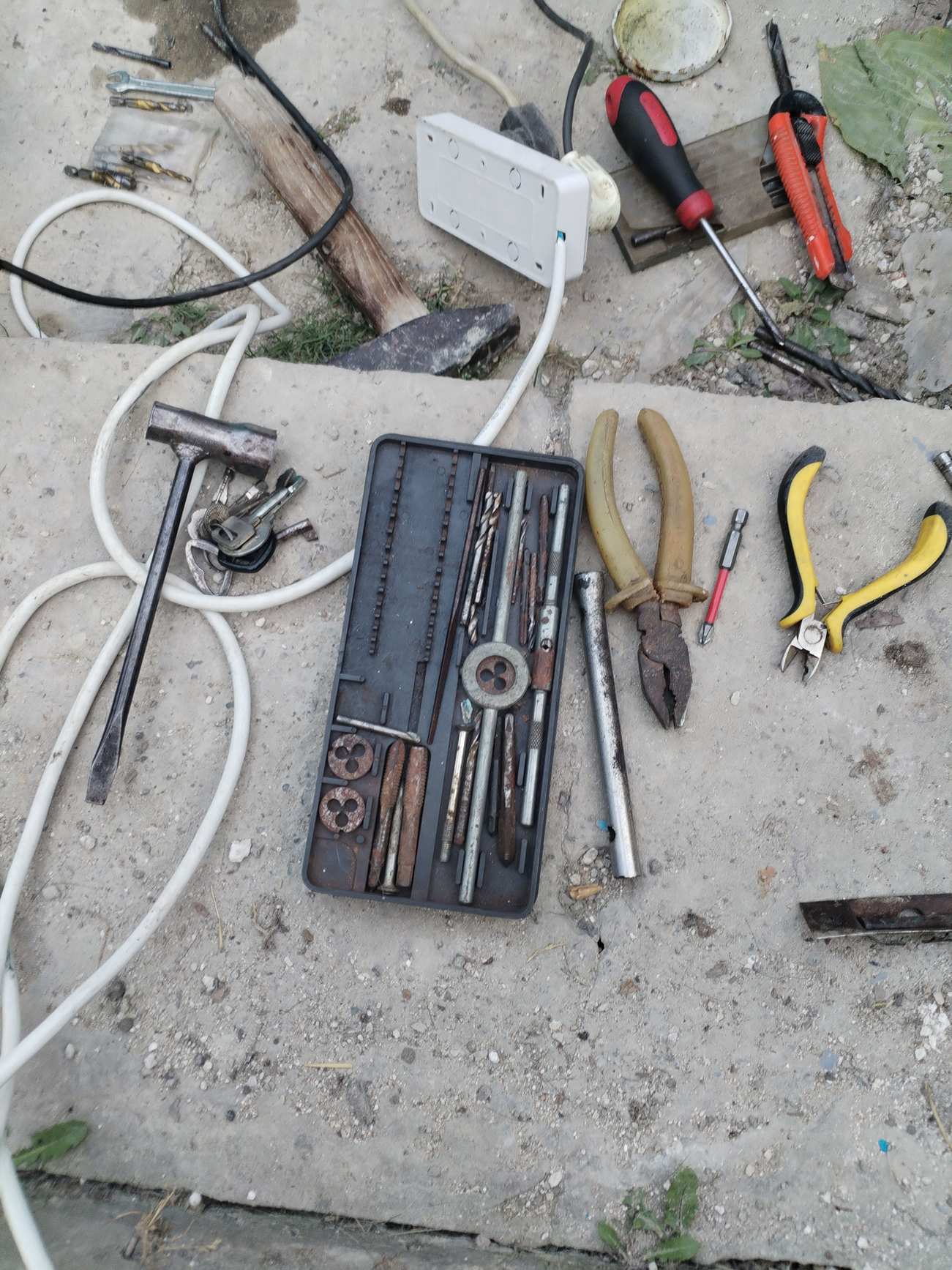 Hand tools arranged on a work surface for repair work
