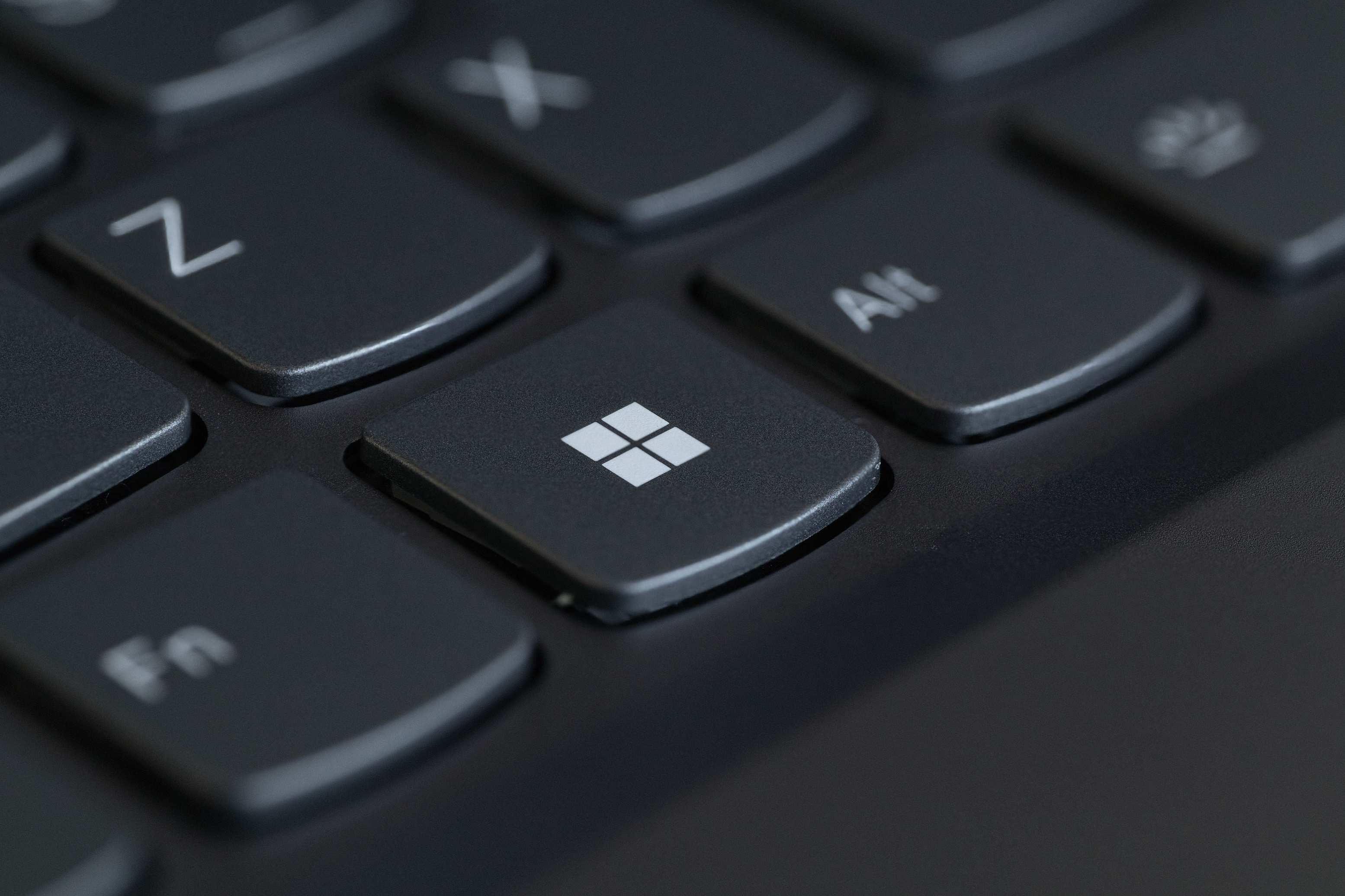 Close view of a computer keyboard featuring the Windows key in focus
